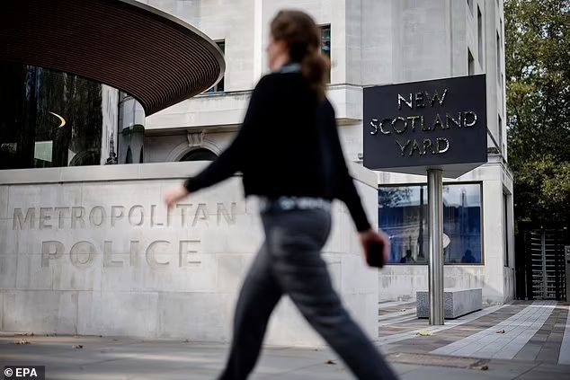 A woman walks past New Scotland Yard